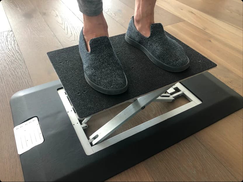 Feet standing on a raised Rizer Mat prototype
